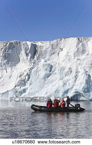 Zodiac cruisers get a view of the tidewater glacier in Isbukta (Ice Bay) on the western side of Spitsbergen Island in the Svalbard Archipelago, Barents Sea, Norway. This glacier is receeding, probably due to global warming. View Large Photo Image Stock Image - Zodiac cruisers get a view of the tidewater glacier in Isbukta (Ice Bay) on the western side of Spitsbergen Island in the Svalbard Archipelago, Barents Sea, Norway. This glacier is receeding, probably due to global warming.. Fotosearch