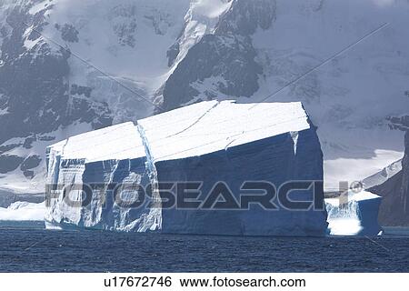 Stock Photograph - A massive tabular iceberg off the coast of Elephant Island in the South Shetland Island Group, Antarctica.. Fotosearch