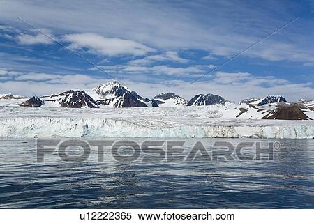 Stock Photography - A view of the tidewater glacier in Isbukta (Ice Bay) on the western side of Spitsbergen Island in the Svalbard Archipelago, Barents Sea, Norway. This glacier is receeding, probably due to global warming.. Fotosearch