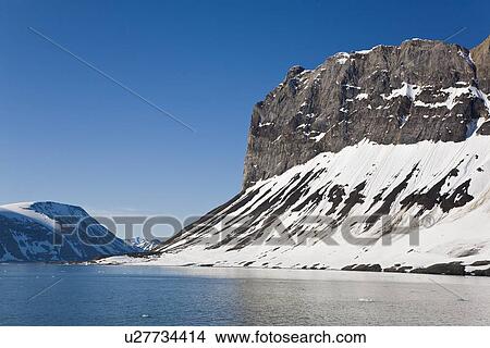 Picture - A view of the towering cliff and glacier in Hornsund (Horn Sound) on the southwestern side of Spitsbergen Island in the Svalbard Archipelago, Barents Sea, Norway.. Fotosearch