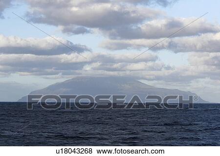 Stock Photo - Approaching the island of Tristan da Cunha from the south, claimed to be the most remote inhabited island in the world.. Fotosearch