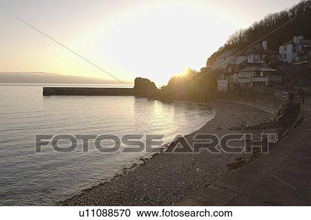 Stock Image - Babbacombe Beach at Sunset. Babbacombe, Torquay, South Devon, UK. Fotosearch