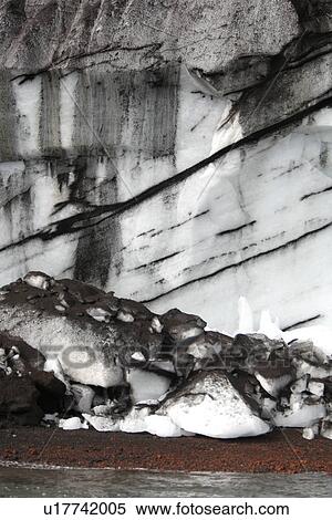 Close up views of glacial ice and ash after the 1969 eruption on Deception Island in Antarctica. Note how the ash is suspended within the ice itself. Though it looks like marble, the dark striations are actually volcanic ash in the ice. View Large Photo Image Stock Photography - Close up views of glacial ice and ash after the 1969 eruption on Deception Island in Antarctica. Note how the ash is suspended within the ice itself. Though it looks like marble, the dark striations are actually volcanic ash in the ice.. Fotosearch