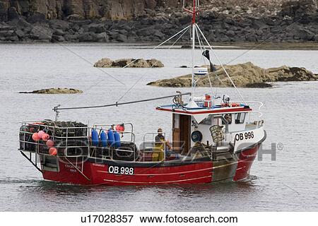 Stock Photo - Creel boat. 'Eilean Ban' shooting creels to catch lobster, crab etc. Hebrides, Scotland. Fotosearch