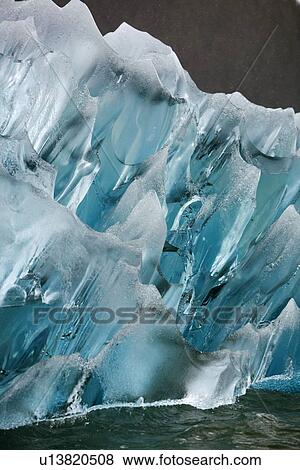 Stock Photo - Deeply blue iceberg calved from the LeConte Glacier just outside Petersburg, Southeast Alaska, USA. Pacific Ocean.. Fotosearch