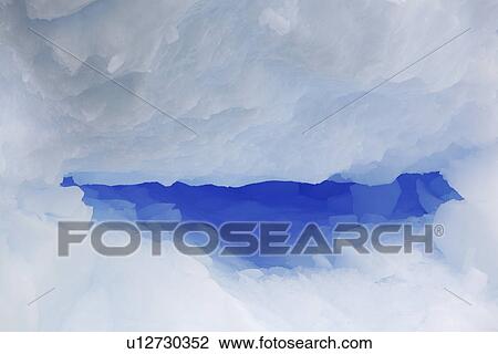 Stock Image - Detail of an intensely blue iceberg adrift in Antarctica.. Fotosearch