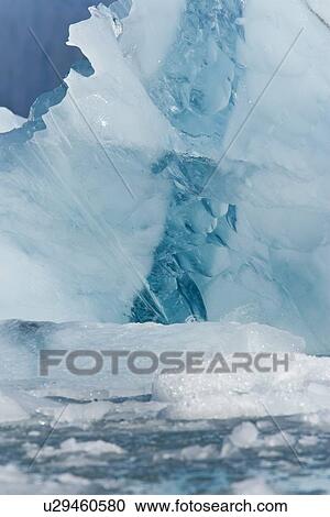Stock Image - Detail of ice calved from Storpollen Glacier, on the southwestern side of Spitsbergen Island in the Svalbard Archipelago, Barents Sea, Norway.. Fotosearch