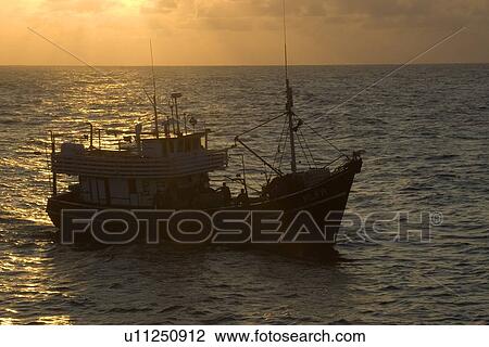 Fishing boat at dusk, St. Peter and St. Paul's rocks, Brazil, Atlantic Ocean View Large Photo Image Stock Image - Fishing boat at dusk, St. Peter and St. Paul's rocks, Brazil, Atlantic Ocean . Fotosearch