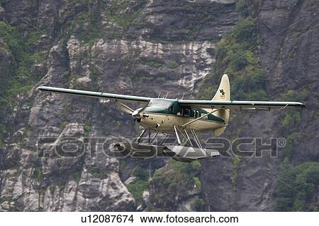 Picture - Flightseeing float planes in and out of the "Punchbowl" rock formation in Kynoch Inlet in Misty Fjords National Monument in Southeast Alaska, USA. Pacific Ocean.. Fotosearch
