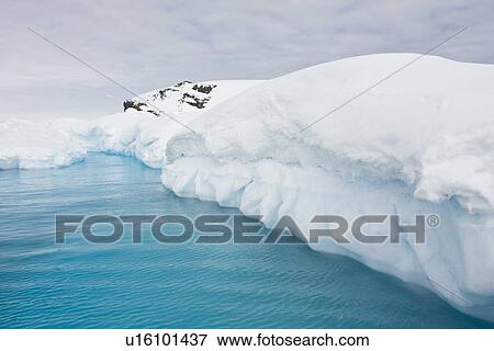 Iceberg detail in and around the Antarctic Peninsula during the summer months. More icebergs are being created as global warming is causing the breakup of major ice shelves and glaciers. View Large Photo Image Stock Photo - Iceberg detail in and around the Antarctic Peninsula during the summer months. More icebergs are being created as global warming is causing the breakup of major ice shelves and glaciers.. Fotosearch