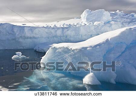 Iceberg detail in and around the Antarctic Peninsula during the summer months. More icebergs are being created as global warming is causing the breakup of major ice shelves and glaciers. View Large Photo Image Stock Photograph - Iceberg detail in and around the Antarctic Peninsula during the summer months. More icebergs are being created as global warming is causing the breakup of major ice shelves and glaciers.. Fotosearch