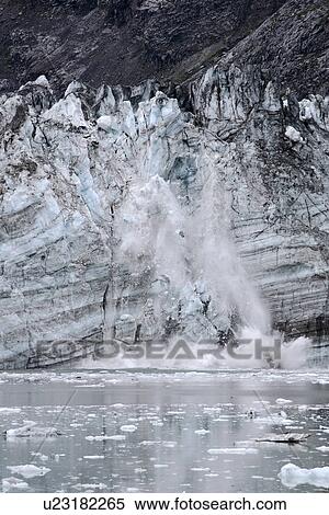 Stock Photography - Johns Hopkins Glacier calving in Glacier Bay National Park, Southeast Alaska, USA. Pacific Ocean. As of the summer of 2006 this was only one of two glaciers still advancing in the park. All the rest are retreating - possibly due to Global Warming?. Fotosearch