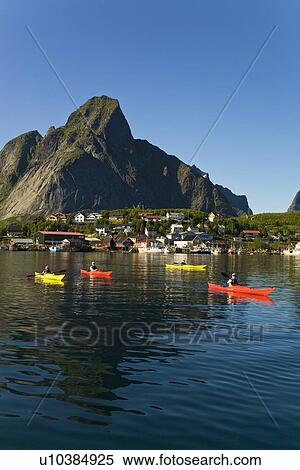 Kayakers in the late evening light on the picturesque Norwegian fishing town of Reine in the Lofoton Island Group, Norway. No model or property releases. View Large Photo Image Stock Photography - Kayakers in the late evening light on the picturesque Norwegian fishing town of Reine in the Lofoton Island Group, Norway. No model or property releases.. Fotosearch