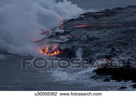 Stock Image - Lava flowing into the Pacific Ocean, Volcanoes National Park, Big Island, Hawaii. Fotosearch
