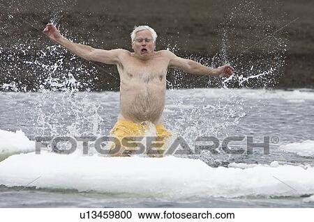 Lindblad Expeditions guest taking the "polar plunge" in Foster Harbor on Deception Island in Antarctica as part of expedition travel. NO MODEL RELEASES FOR THIS IMAGE. View Large Photo Image Stock Image - Lindblad Expeditions guest taking the "polar plunge" in Foster Harbor on Deception Island in Antarctica as part of expedition travel. NO MODEL RELEASES FOR THIS IMAGE.. Fotosearch