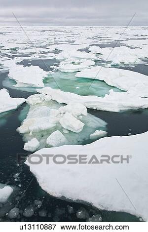 Stock Photo - Open leads surrounded by multi-year ice floes in the Barents Sea between EdgeÏya (Edge Island) and Kong Karls Land in the Svalbard Archipelago, Norway.. Fotosearch