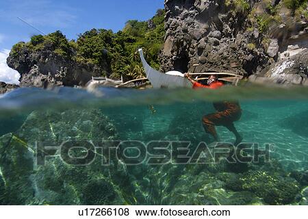 Over under of banca and sandy seafloor, Apo island Marine Reserve, Philippines View Large Photo Image Stock Photo - Over under of banca and sandy seafloor, Apo island Marine Reserve, Philippines. Fotosearch