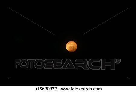 Stock Image - Smoke covering sun from oil refinery on fire. Island in Arabian Gulf. Fotosearch