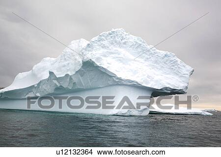 Strange and wonderful formations in the icebergs and bergy bits in and around the Antarctic Peninsula during the summer months. View Large Photo Image Picture - Strange and wonderful formations in the icebergs and bergy bits in and around the Antarctic Peninsula during the summer months.. Fotosearch