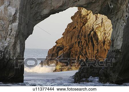 Sunrise on the famous finisterra arch at (lands end) rock formation in Cabo San Lucas, Baja California Sur, Mexico. | View Large Photo Image Picture - Sunrise on the famous finisterra arch at (lands end) rock formation in Cabo San Lucas, Baja California Sur, Mexico. |. Fotosearch