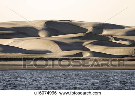 Stock Photograph - Sunrise on the sand dunes of Isla Magdalena on the Baja California penninsula.. Fotosearch