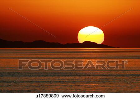 Stock Photo - Sunrise over the calm waters of the Gulf of California (Sea of Cortez), Baja, Mexico.. Fotosearch