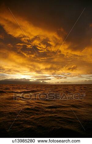 Stock Image - Sunset across the AuAu Channel between Maui and Lanai, looking west with Lanai in the background. Maui, Hawaii, USA.. Fotosearch