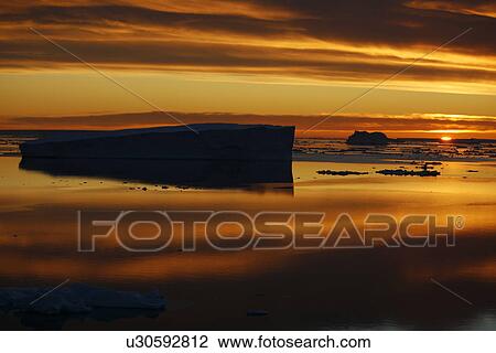 Sunset on fresh sea ice and tabular icebergs in the Weddell Sea, Antarctica. View Large Photo Image Stock Image - Sunset on fresh sea ice and tabular icebergs in the Weddell Sea, Antarctica.. Fotosearch