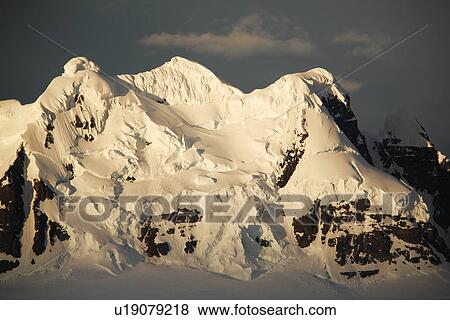 Sunset on snow covered peaks in the magnificent Lemaire Channel, Antarctica. View Large Photo Image Stock Photo - Sunset on snow covered peaks in the magnificent Lemaire Channel, Antarctica.. Fotosearch