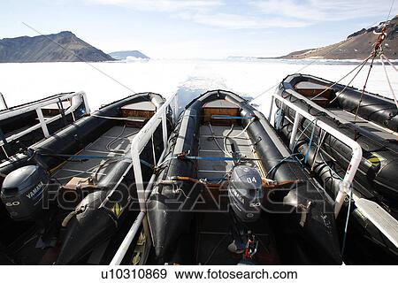 Stock Photo - The National Geographic Endeavour and its inflatable Zodiacs breaking through fast ice in and around the Antarctic Peninsula.. Fotosearch