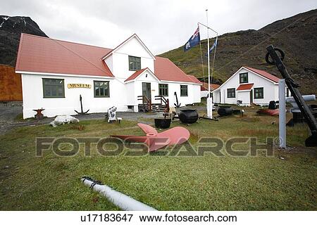 Stock Photo - The new whaling museum and abandoned machinery at the Grytviken whaling station established by the Norwegian whaler C. A. Larsen in 1904. The station operated until December 4th, 1964. In that time it housed roughly 300 men and processed more than 54, 000 w. Fotosearch