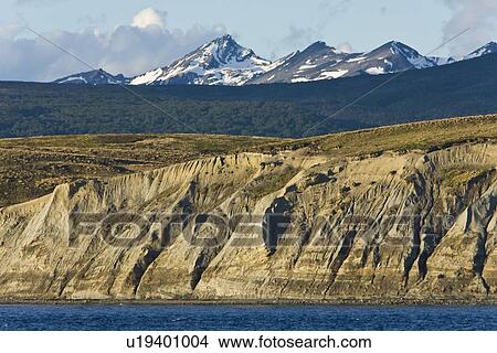 Picture - Views of the Beagle Channel, South America. This channel represents the end of the Andes Mountains and the north/south border between Argentina (north) and Chile (south) side of the channels. The border between the two countries runs down the middle of th. Fotosearch