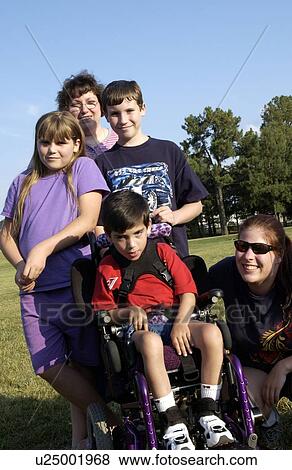 Stock Photo - Boy with a disability hanging out with his friends in the park.. Fotosearch