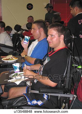 Boys, in wheelchairs, eating at Muscular Dystrophy Association Summer Camp. View Large Photo Image Stock Photo - Boys, in wheelchairs, eating at Muscular Dystrophy Association Summer Camp.. Fotosearch
