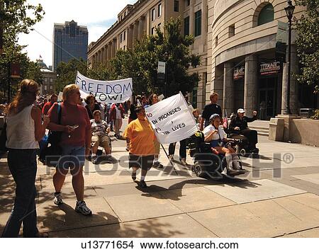 Large crowd of people with and without disabilities marching to the State Capitol. View Large Photo Image Picture - Large crowd of people with and without disabilities marching to the State Capitol.. Fotosearch