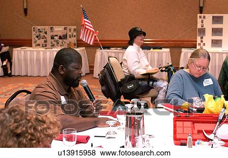 Man with a disability speaking at a conference for and about people with disabilities. View Large Photo Image Stock Photo - Man with a disability speaking at a conference for and about people with disabilities.. Fotosearch