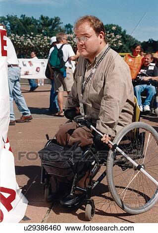 Man with a disability who utilizes a wheelchair for mobility attending a national disability advocacy event. View Large Photo Image Stock Image - Man with a disability who utilizes a wheelchair for mobility attending a national disability advocacy event.. Fotosearch