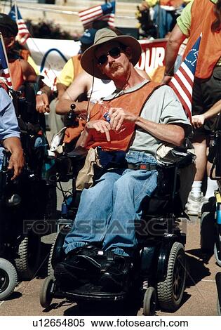 Man with cerebral palsy who utilizes a wheelchair for mobility participating in a civil rights event. View Large Photo Image Stock Photography - Man with cerebral palsy who utilizes a wheelchair for mobility participating in a civil rights event.. Fotosearch