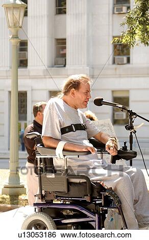 Man with multiple disabilities speaking to a group of self-advocates and activists at a rally to advocate for the civil rights of people with disabilities. View Large Photo Image Stock Photograph - Man with multiple disabilities speaking to a group of self-advocates and activists at a rally to advocate for the civil rights of people with disabilities.. Fotosearch