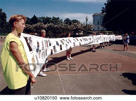 Stock Image - People holding a banner depicting images of people with disabilities whose civil rights have been violated due to prohibitive policies and regulations.. Fotosearch