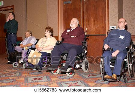 People with disabilities, all utilizing wheelchairs for mobility, listening to a keynote speaker at a conference. View Large Photo Image Stock Image - People with disabilities, all utilizing wheelchairs for mobility, listening to a keynote speaker at a conference.. Fotosearch