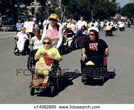 Stock Photography - People with disabilities participating in a Freedom March to advocate for the civil rights of people with disabilities.. Fotosearch