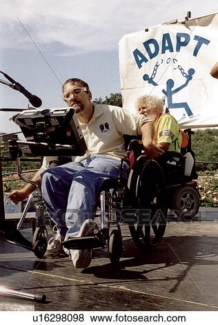 Stock Photo - Person with a disability using his assistive technology communication device to speak to a crowd of people with disabilities at a national disability civil rights event.. Fotosearch