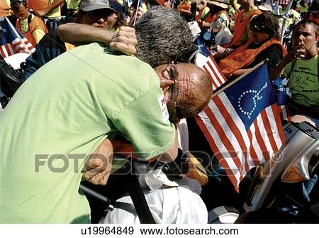 Powerful image of two people in an emotional embrace - one person with significant disabilities who utilizes a wheelchair - during a national disability civil rights event. View Large Photo Image Stock Photo - Powerful image of two people in an emotional embrace - one person with significant disabilities who utilizes a wheelchair - during a national disability civil rights event.. Fotosearch