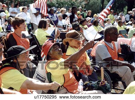 Stock Photography - Scene from a crowd of people with disabilities waving flags and shouting at a national disability civil rights event in Washington, D. C.. Fotosearch
