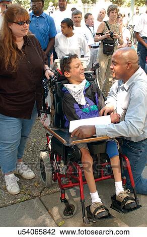 Teenager with severe disabilities interacting with other participants at a Freedom Rally to advocate for the civil rights of people with disabilities. View Large Photo Image Stock Image - Teenager with severe disabilities interacting with other participants at a Freedom Rally to advocate for the civil rights of people with disabilities.. Fotosearch