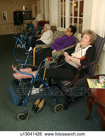 Two ladies rest, while others visit with each other. View Large Photo Image Stock Photograph - Two ladies rest, while others visit with each other.. Fotosearch