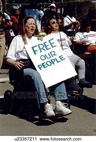 Woman with a disability holding a sign FREE OUR PEOPLE participating with other people with disabilities at a national disability civil rights event. View Large Photo Image Stock Image - Woman with a disability holding a sign FREE OUR PEOPLE participating with other people with disabilities at a national disability civil rights event.. Fotosearch