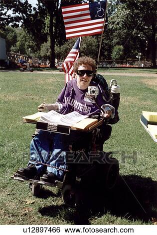 Woman with a disability who utilizes a power wheelchair for mobility, demonstrating via her VOLUNTEER t-shirt that people with disabilities do have something to offer! View Large Photo Image Stock Photograph - Woman with a disability who utilizes a power wheelchair for mobility, demonstrating via her VOLUNTEER t-shirt that people with disabilities do have something to offer!. Fotosearch