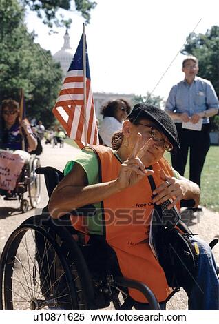 Stock Photography - Woman with a disability who utilizes a wheelchair for mobility displaying the. Fotosearch